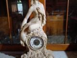 A COLLECTIBLE UNIQUE MARBLE STATUE OF A LADY SEATED ON A CLOCK.